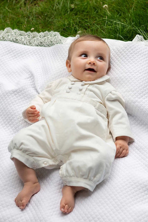 Barboteuse baptême bébé garçon Paul pour l'hiver en velours de coton doublée polaire. Création française Fil de Légende. Photo de la barboteuse portée par un bébé garçon allongé