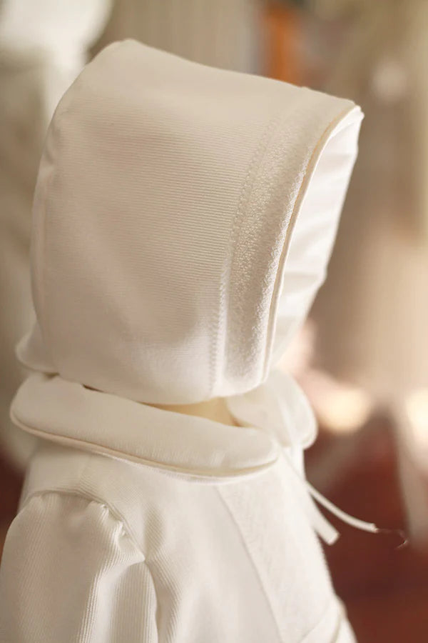 Bonnet de baptême bébé garçon en velours blanc cassé et dentelle fine. Création française Fil de Légende. Disponible en ligne et en boutique à Paris, Neuilly-sur-Seine.