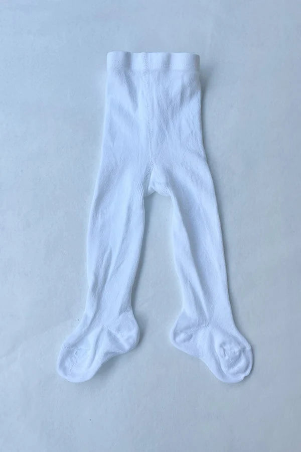 Collant blanc épais en coton chaud pour bébé fille. Idéal à porter avec une robe de cérémonie bébé blanche. Boutique Fil de Légende à Paris, Neuilly-sur-Seine.